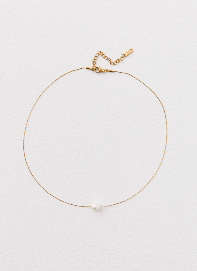 Womens Heartstrings Pearl Necklace in the colour Ivory in front of a light grey background