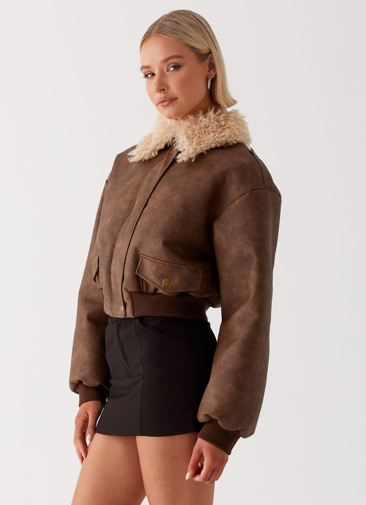 Womens Aston Shearling Bomber Jacket in the colour Brown in front of a light grey background