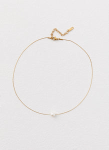 Womens Heartstrings Pearl Necklace in the colour Ivory in front of a light grey background