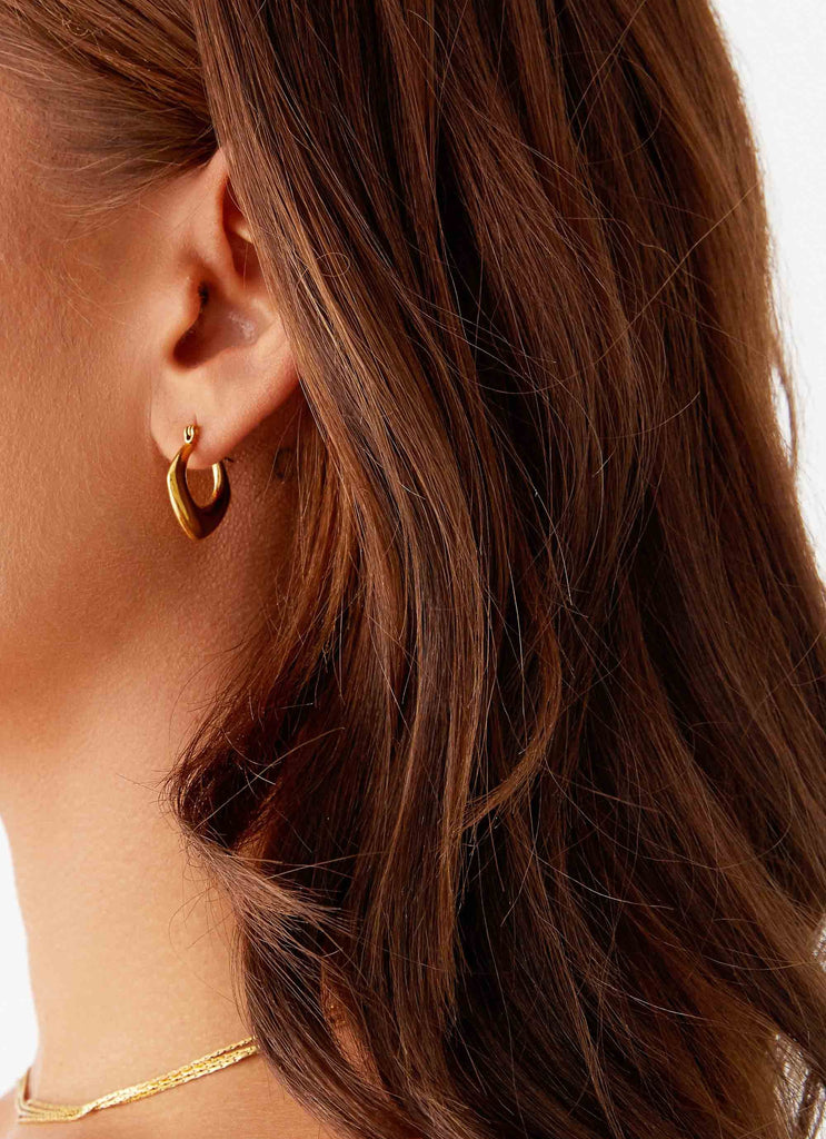 Womens High Voltage Earrings in the colour Gold in front of a light grey background