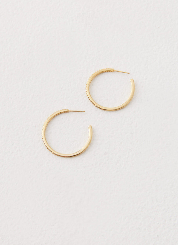 Womens Lilyanna Earrings in the colour Gold in front of a light grey background