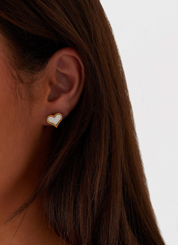 Womens Lois Heart Earrings in the colour Gold in front of a light grey background