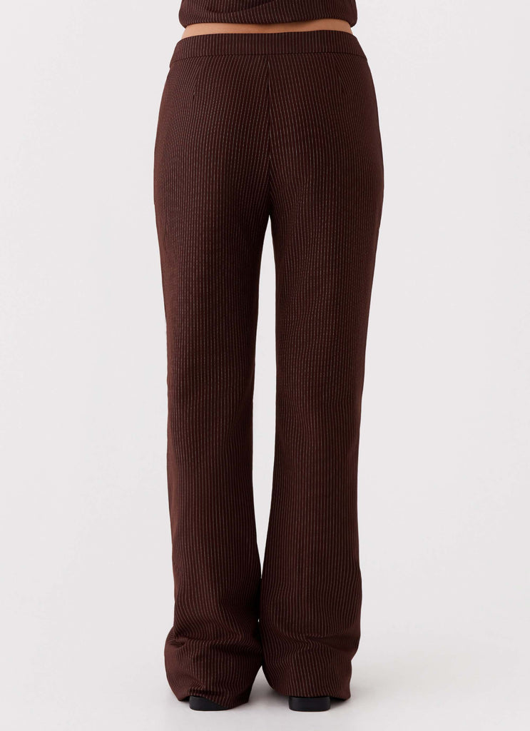 Womens Orla Fitted Flare Pants in the colour Chocolate in front of a light grey background