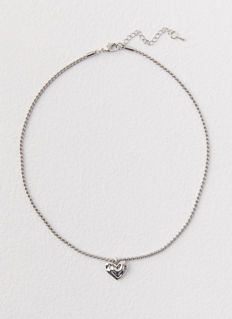 Womens Pending Heart Necklace in the colour Silver in front of a light grey background