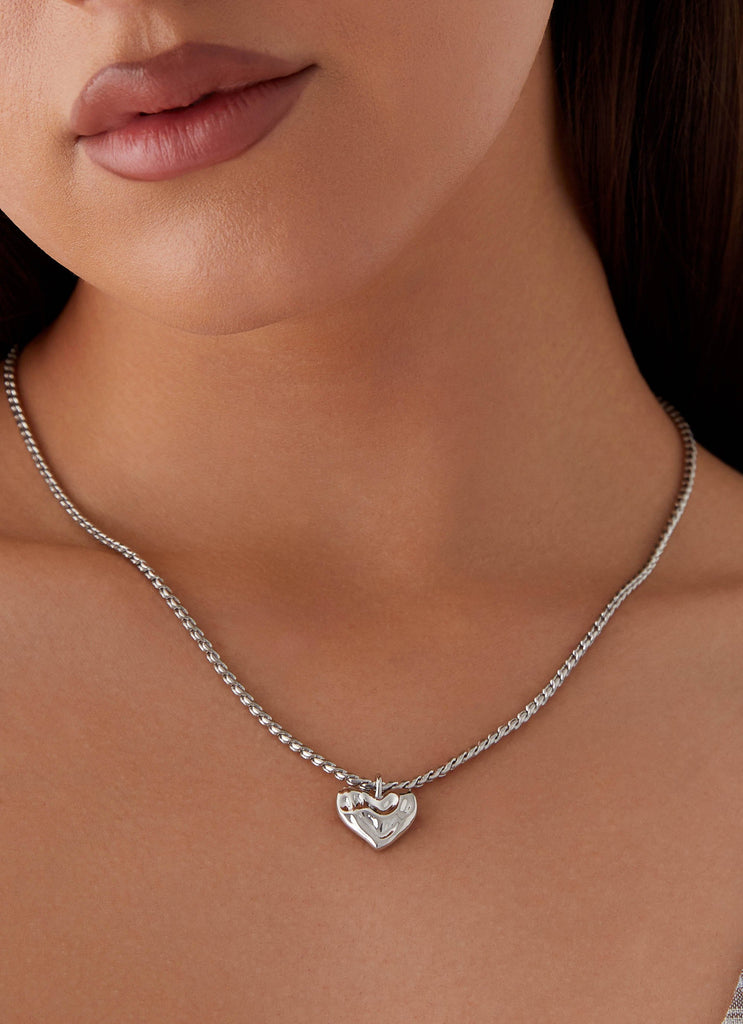 Womens Pending Heart Necklace in the colour Silver in front of a light grey background