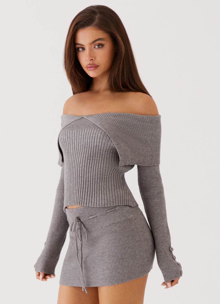 Womens Frankie Arrow Knit Long Sleeve Top in the colour Charcoal in front of a light grey background