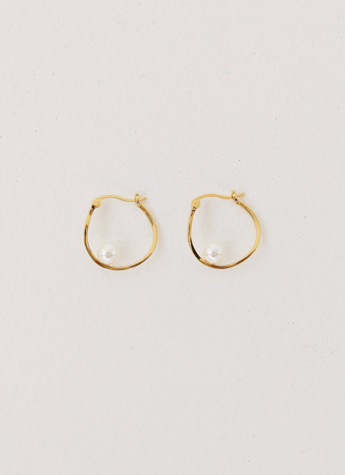 Womens Cosima Abstract Hoop Earring in the colour Gold in front of a light grey background