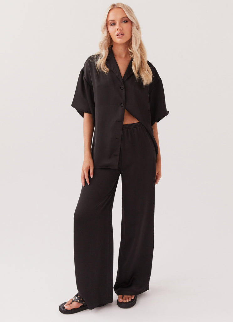 Womens Palm Cove Satin Pants in the colour Black in front of a light grey background