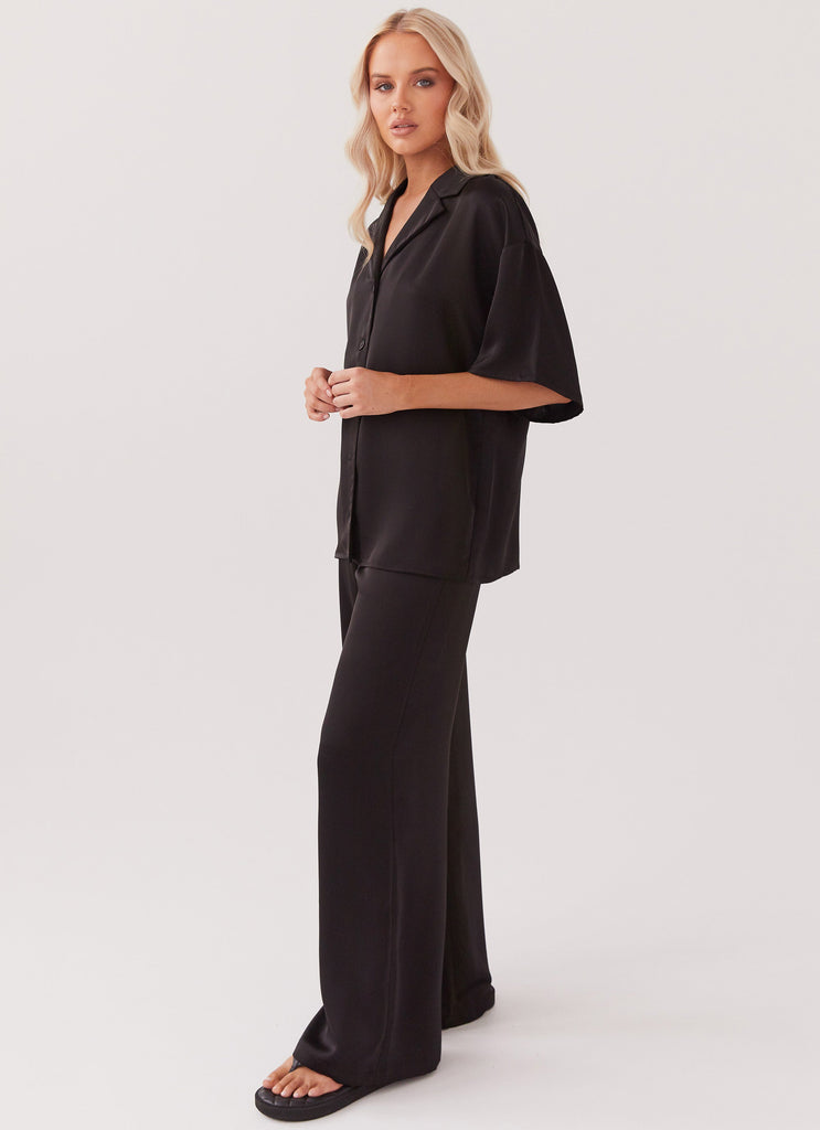 Womens Palm Cove Satin Pants in the colour Black in front of a light grey background