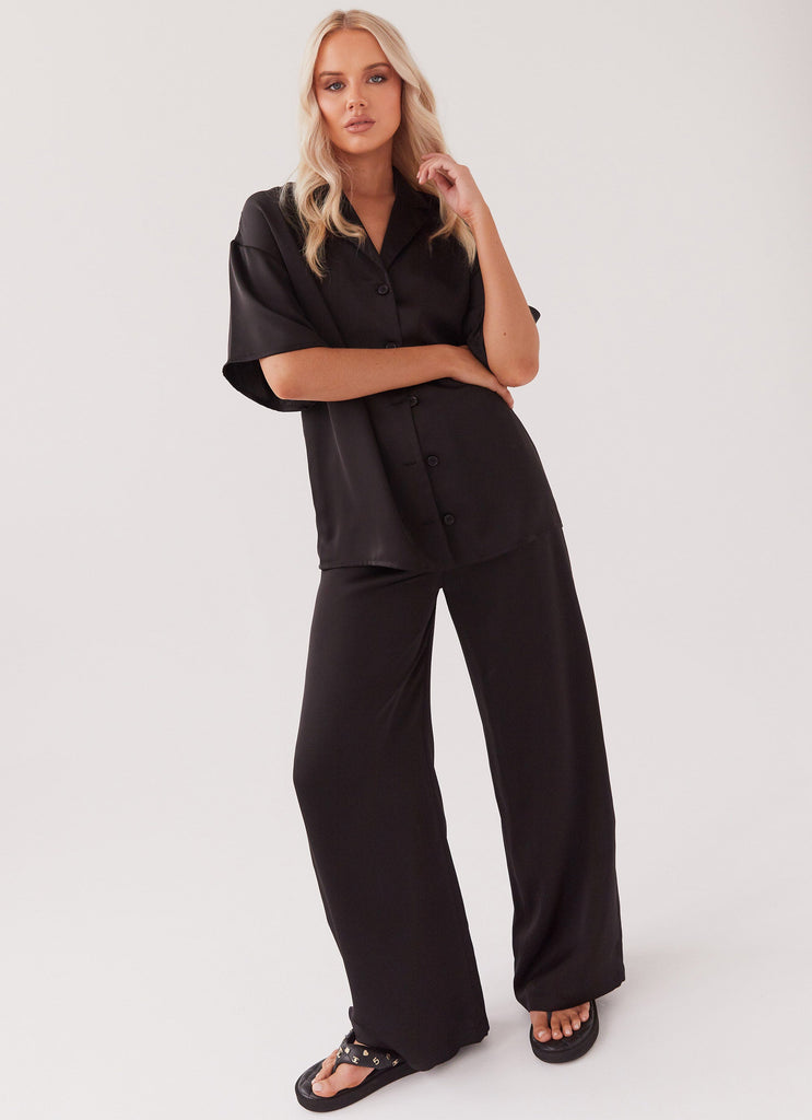 Womens Palm Cove Satin Pants in the colour Black in front of a light grey background