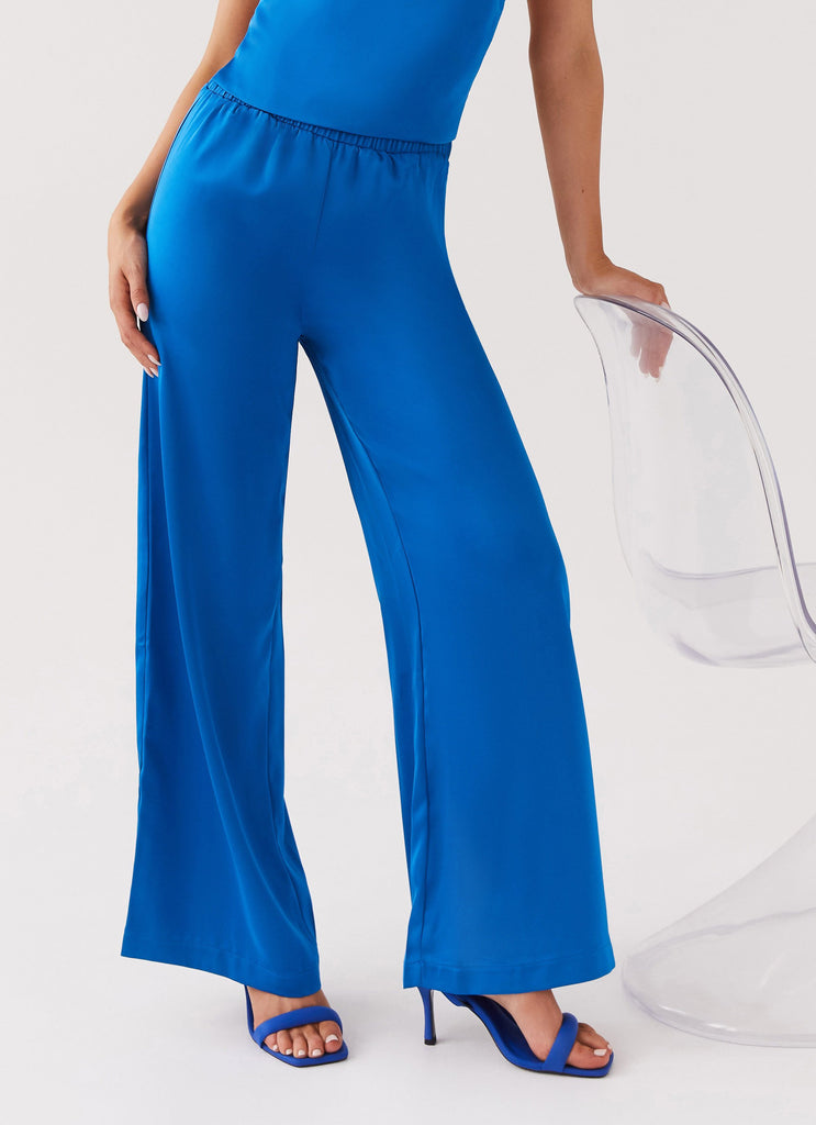 Womens Palm Cove Satin Pants in the colour Cobalt in front of a light grey background