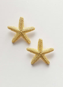Womens Geneve Starfish Earring in the colour Gold in front of a light grey background