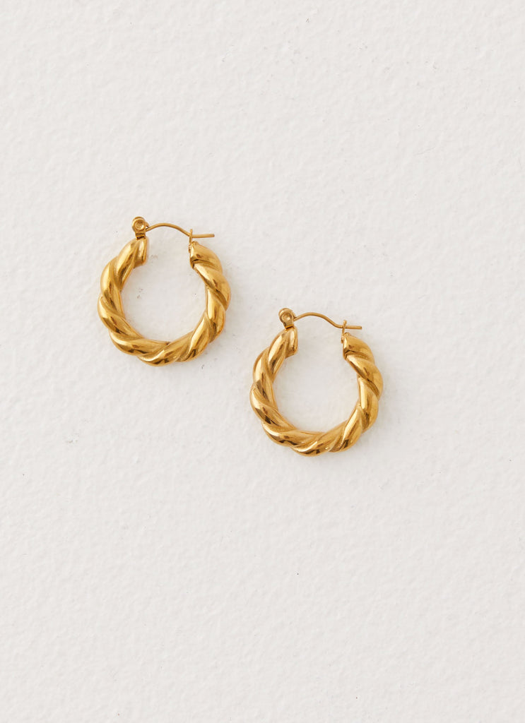 Womens Priscilla Earrings in the colour Gold in front of a light grey background