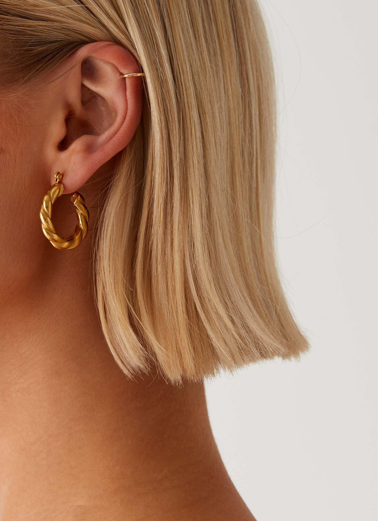 Womens Priscilla Earrings in the colour Gold in front of a light grey background